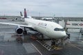 Delta Airbus A330 Plane at a Gate during a Rainy Day at JFK Airport in New York City