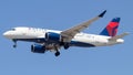 Delta Airlines aircraft soaring against a blue sky backdrop.