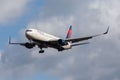 Delta Airlines Boeing 767-332 isolated in the air with clouds in the background