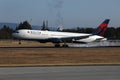 Delta Airlines plane landing on runway, touchdown