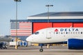 Delta Commercial Airliner on Tarmac and American Flag