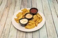 Deluxe chicano potatoes with assorted sauces on white plate