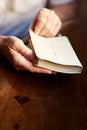 Delving into the Good Book. a man opening a bible. Royalty Free Stock Photo