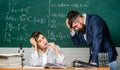 Demanding lecturer. Teacher strict serious bearded man having conflict with student girl. Rebuke and punishment. You Royalty Free Stock Photo