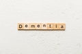 Dementia word written on wood block. Dementia text on cement table for your desing, concept Royalty Free Stock Photo