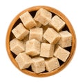 Demerara brown sugar cubes in wooden bowl over white Royalty Free Stock Photo