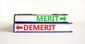 Demerit or merit symbol. Concept word Demerit or Merit on beautiful books. Beautiful white table white background. Business and