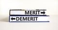 Demerit or merit symbol. Concept word Demerit or Merit on beautiful books. Beautiful white table white background. Business and