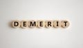 Demerit symbol. The concept word Demerit on wooden circles. Beautiful white background, copy space. Business and demerit concept