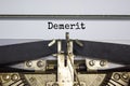 Demerit symbol. The word `demerit` typed on retro typewriter. Business, demerit concept. Beautiful white background