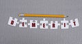 DEMERIT is a word made up of paper white puzzles on a gray background and in pencil