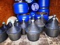 Demijohns with lid and blue barrels