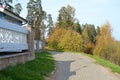 Demino / Rybinsk, Russia - October 3, 2020: Rest in a country park. A winding path going deep into the forest with tall trees and