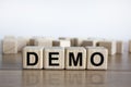 Demo symbol. Concept word `demo` on cubes on a beautiful wooden table. White background. Business and demo concept. Copy space