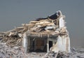 Demolished house under big heap of debris