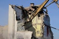 Demolished old soviet union building remains with bulldozer