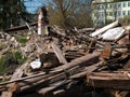 Demolished old wooden house and brick chimney on a sunny day Royalty Free Stock Photo