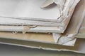 Demolished plasterboard wall, made of plaster and cardboard, with fragments of material and dust in a construction site Royalty Free Stock Photo