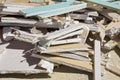 Demolished plasterboard wall, made of plaster and cardboard, with fragments of material and dust in a construction site Royalty Free Stock Photo
