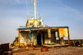 Demolished and rusty deck of a cargo ship with old bridge, mast, antennas and machinery. Royalty Free Stock Photo