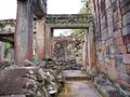 Demolished stone rock door frame at Preah Khan temple Angkor Wat complex, Siem Reap Cambodia. A popular tourist attraction nestled