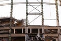 Demolition of the arena. Old metal frame of the building, destroyed walls.