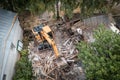 Demolition of building aerial view. Excavator breaks old house. Freeing up space for construction of new building Royalty Free Stock Photo