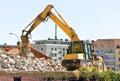 Demolition of a building by an excavator Royalty Free Stock Photo