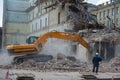 Demolition of building. Excavator breaks old house. Freeing up space for construction of new building Royalty Free Stock Photo