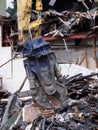 Demolition claw removing debris and rubble from a wrecked building damaged by fire Royalty Free Stock Photo