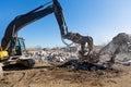 Demolition Excavator Pulverizer with Hydraulic Crusher Shearing Equipment Working at Construction Site Royalty Free Stock Photo