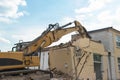 Demolition of a house by an excavator