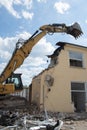 Demolition of a house by an excavator