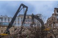 Demolition of a multi-storey building with hydraulic shears, for future development of residential buildings Royalty Free Stock Photo