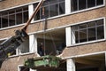 Demolition of old brick building with help of high reach excavators.