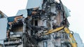 Demolition of an old building, time-lapse. Excavator destroys old building