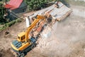 Demolition of old house building for new construction by excavator bucket, aerial view. City development Royalty Free Stock Photo