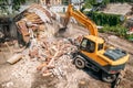 Demolition of old house building for new construction by excavator bucket, aerial view. City development Royalty Free Stock Photo