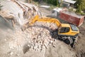 Demolition of old house building for new construction by excavator bucket, aerial view. City development Royalty Free Stock Photo