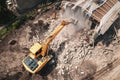 Demolition of old house building for new construction by excavator bucket, aerial view. City development Royalty Free Stock Photo