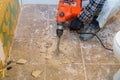 Demolition of old tiles with jackhammer. Renovation of old floor Royalty Free Stock Photo