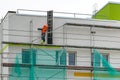 Demolition of scaffolding after thermal insulation and painting of the facade of an apartment house