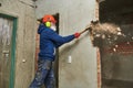 Demolition work and rearrangement. worker with sledgehammer destroying wall Royalty Free Stock Photo