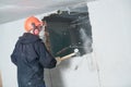 Demolition work and rearrangement. worker with sledgehammer destroying wall