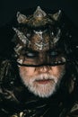 Demon with golden skin and thorns covering his eyes with dark veil. Frightening glance of ancient monster rising from Royalty Free Stock Photo