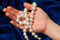 Demonstrating a pearls necklace