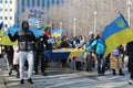 Protestors carry signs and Ukrainian flags at march against Russian invasion of Ukraine in Chicago.