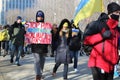 Protestors carry signs and Ukrainian flags at march against Russian invasion of Ukraine in Chicago.