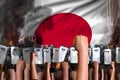 Protest in Japan - police guards stand against the protesting crowd on flag background, mutiny stopping concept, military 3D