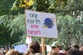 Demonstration during Global Climate Strike with cardboard banner saying `One earth, one heart`